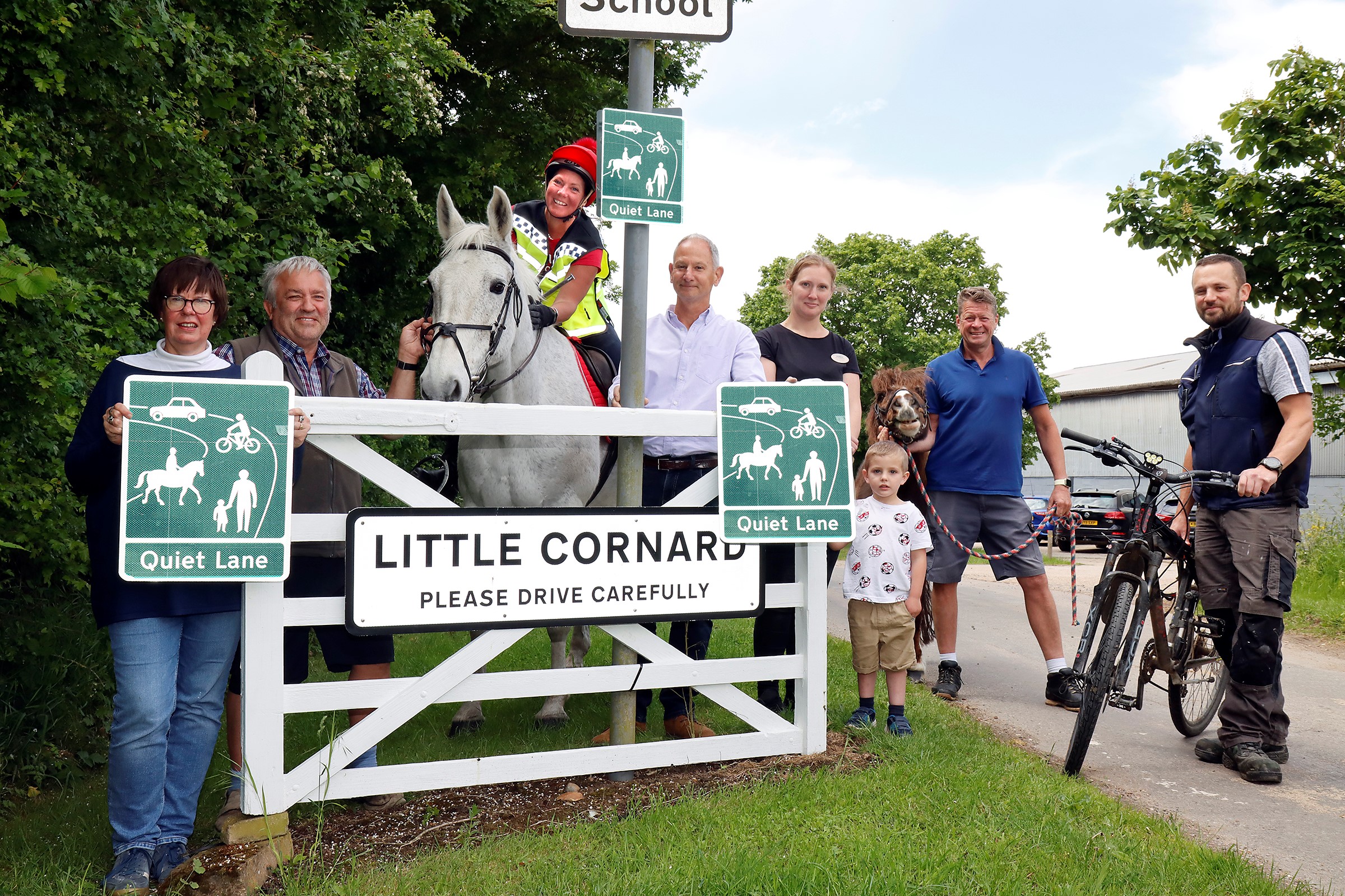 A photo of people at the entrance to Little Cornard, holding quiet lane signs. Ruth Adams and Clive Johnson of Little Cornard Parish Council, Andrea Last of Dorking Tye on Greyness, Mark Irwin, Little Cornard councillor, Charlotte Bradshaw of Yorley Barn Nursery and her son Jake, Mark Rendall holding The Commander, and local farmer James Johnson. (Picture: Paul Nixon, Paul Nixon Photography)