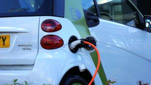 A white electric car charging. 